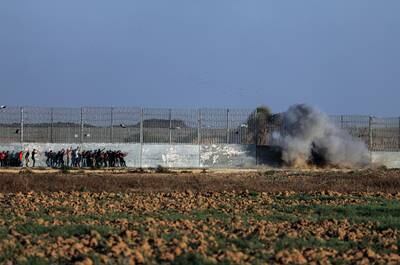Smoke rises after Palestinian protesters detonate a bomb at the border wall during clashes on the eastern border of the Gaza Strip. EPA