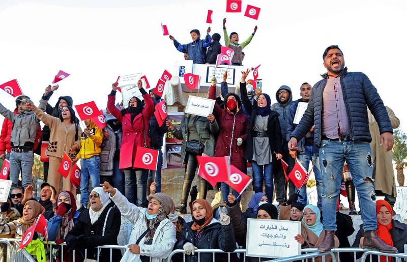 Unemployed Tunisian graduates chant slogans during a demonstration to mark the 10th anniversary of the start of the 2011 revolution in Sidi Bouzid. AFP