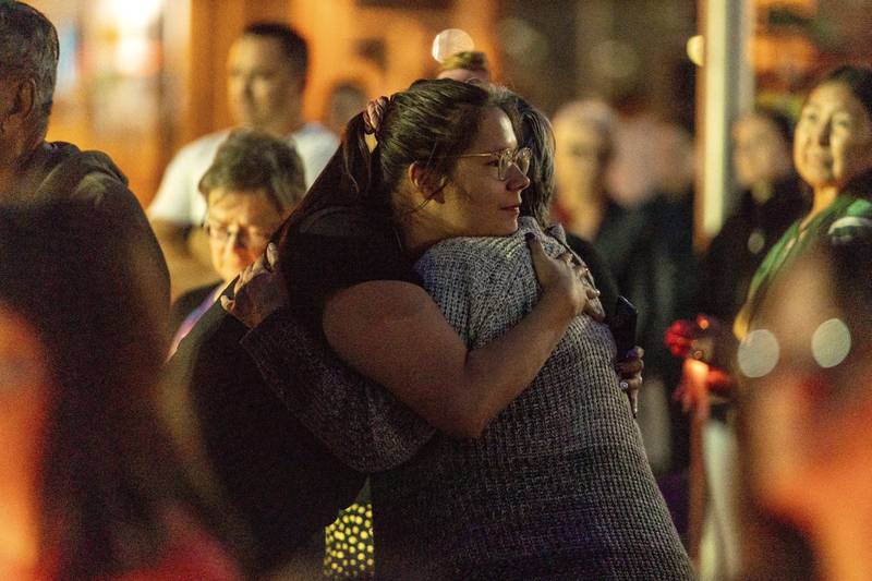People embrace during a vigil in honour of the victims of a mass stabbing incident, in Prince Albert, Saskatchewan. AP