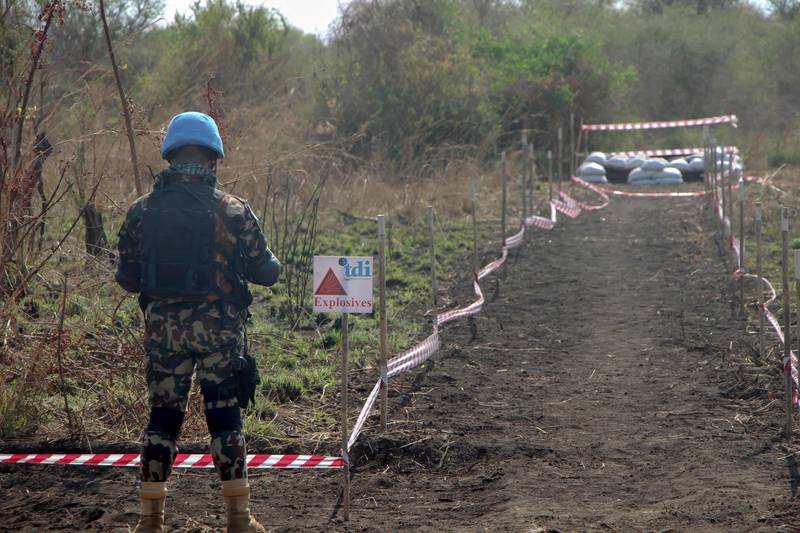 A UN peacekeeper secures the site of a planned controlled-detonation of landmines. AFP