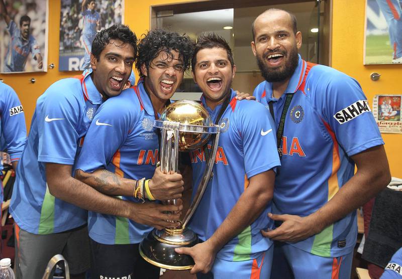 MUMBAI, INDIA - APRIL 02: Ravichandran Ashwin (L),Shanthakumaran Sreesanth (2L),Suresh Raina (2R) and Yusuf Pathan (R) pose with the world cup trophy in the players dressing room after their six wicket victory in the 2011 ICC World Cup Final between India and Sri Lanka at Wankhede Stadium on April 2, 2011 in Mumbai, India.  (Photo by Michael Steele/Getty Images)