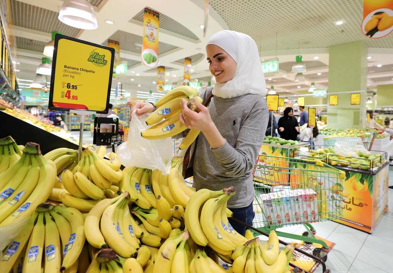 Abu Dhabi, United Arab Emirates - May 05, 2019: Shahed Mardini picks out some bananas. People shopping for Ramadan. Sunday the 5th of May 2019. Al Wahda Mall, Abu Dhabi. Chris Whiteoak / The National