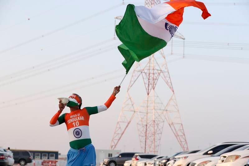 A cricket fan flies the Indian flag outside Zayed Cricket Stadium, Abu Dhabi. Khushnum Bhandari/ The National