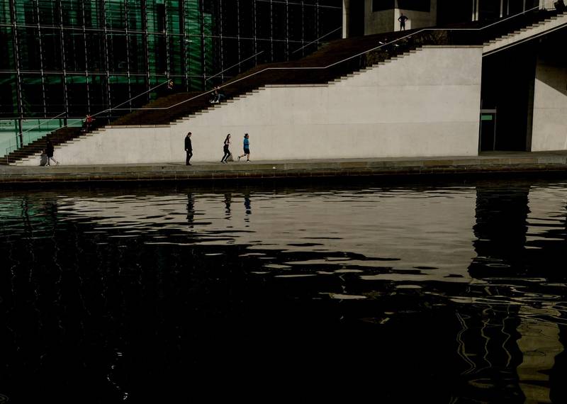People walk at the banks of the river Spree during sunny weather in a quiet Berlin. EPA