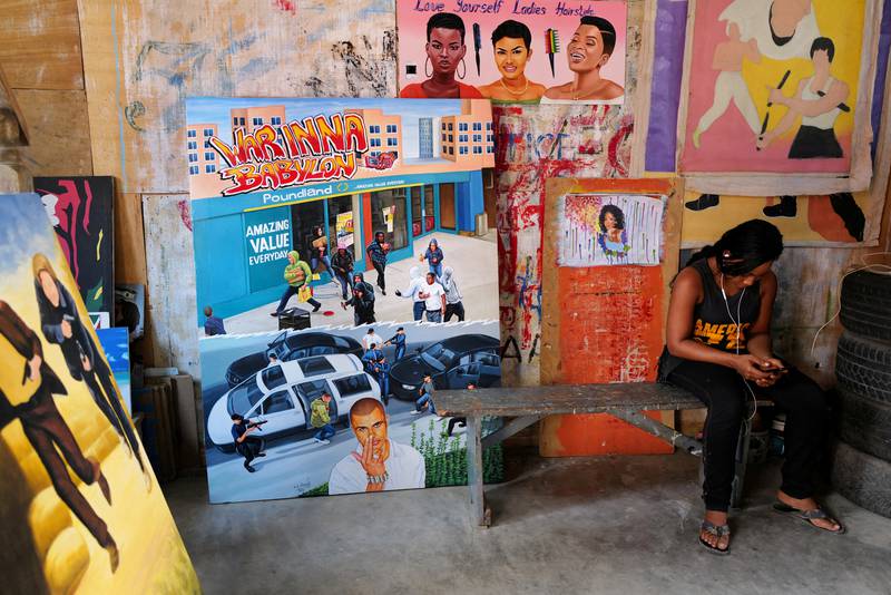 Apprentice Joana Tackie, 24, in the workshop of Ghanaian film poster artist Daniel Anum Jasper in Teshie, Ghana. Reuters