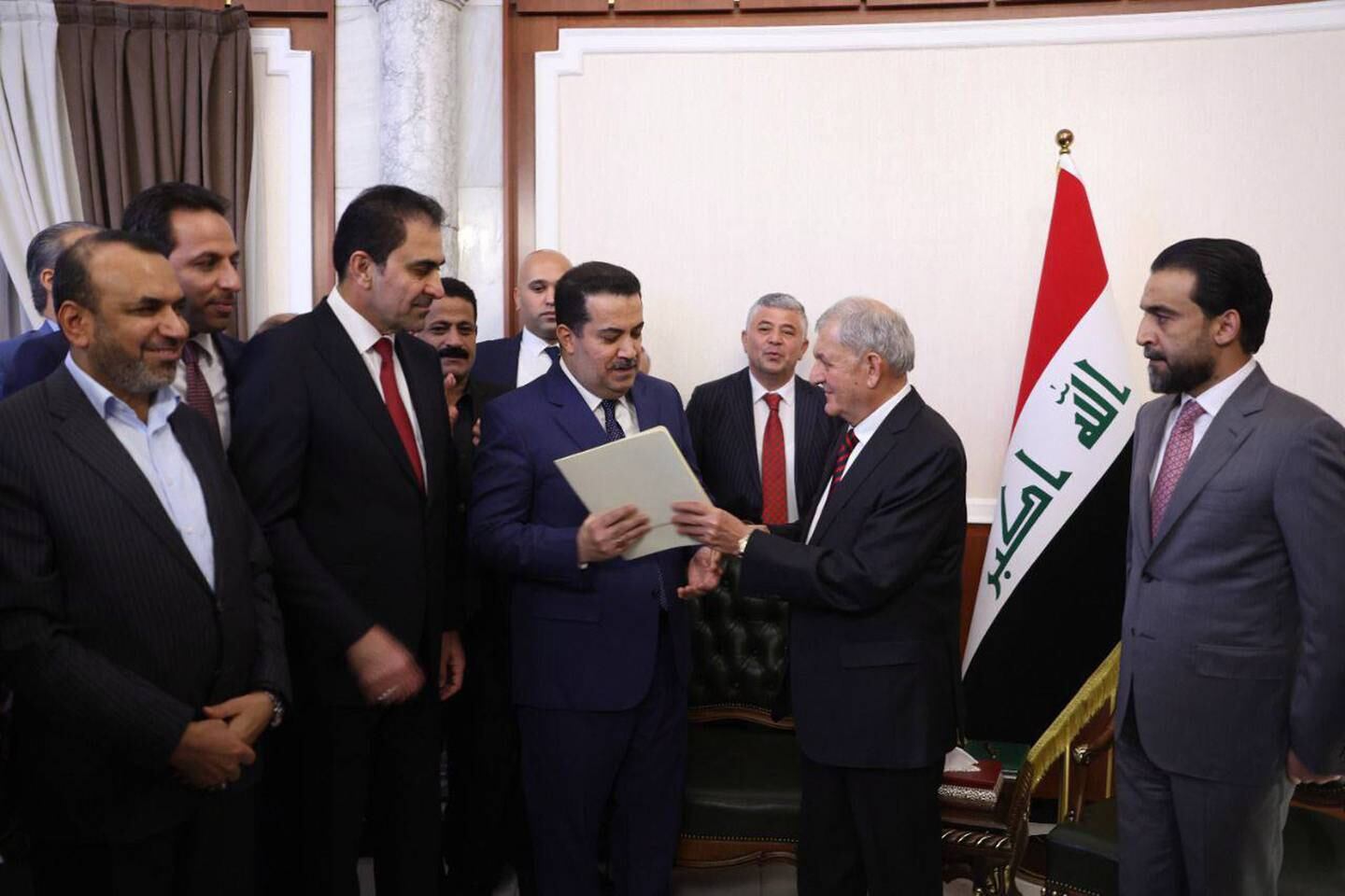 A handout photo made available by Iraqi Parliament Media Office shows New iraq's president Abdul Lateef Rasheed (2-R) hands over the letter of assignment to form a new government to the nominated Prime Minister Mohammed Shia Al Sudani (C) at the Iraqi Parliament in Baghdad, Iraq on 13 October 2022. EPA