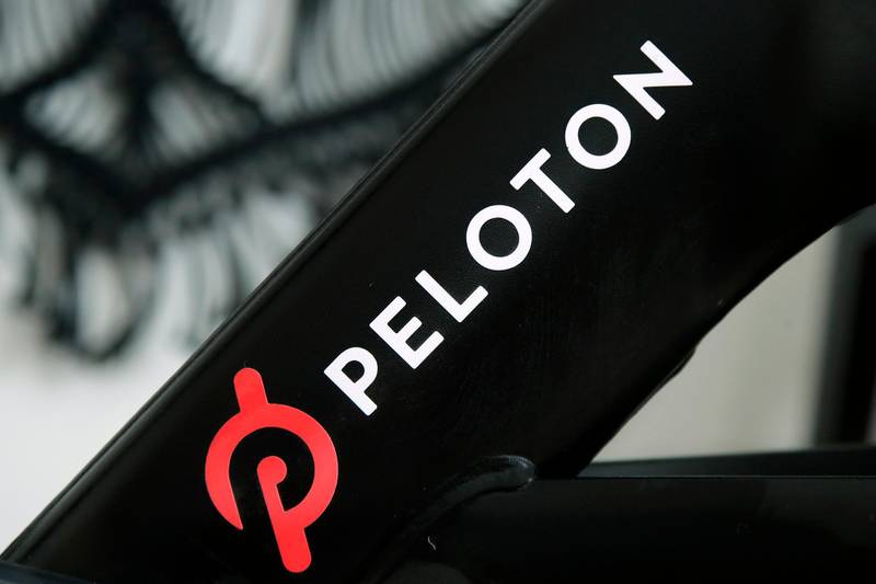 FILE - This Nov. 19, 2019 file photo shows a Peloton logo on the company's stationary bicycle in San Francisco.   Safety regulators are warning people with kids and pets to immediately stop using a treadmill made by Peloton after one child died and nearly 40 others were injured. The U.S. Consumer Product Safety Commission said Saturday, April 17, 2021, that it received reports of children and a pet being pulled, pinned and entrapped under the rear roller of the treadmill, leading to fractures, scrapes and the death of one child.  (AP Photo/Jeff Chiu, File)
