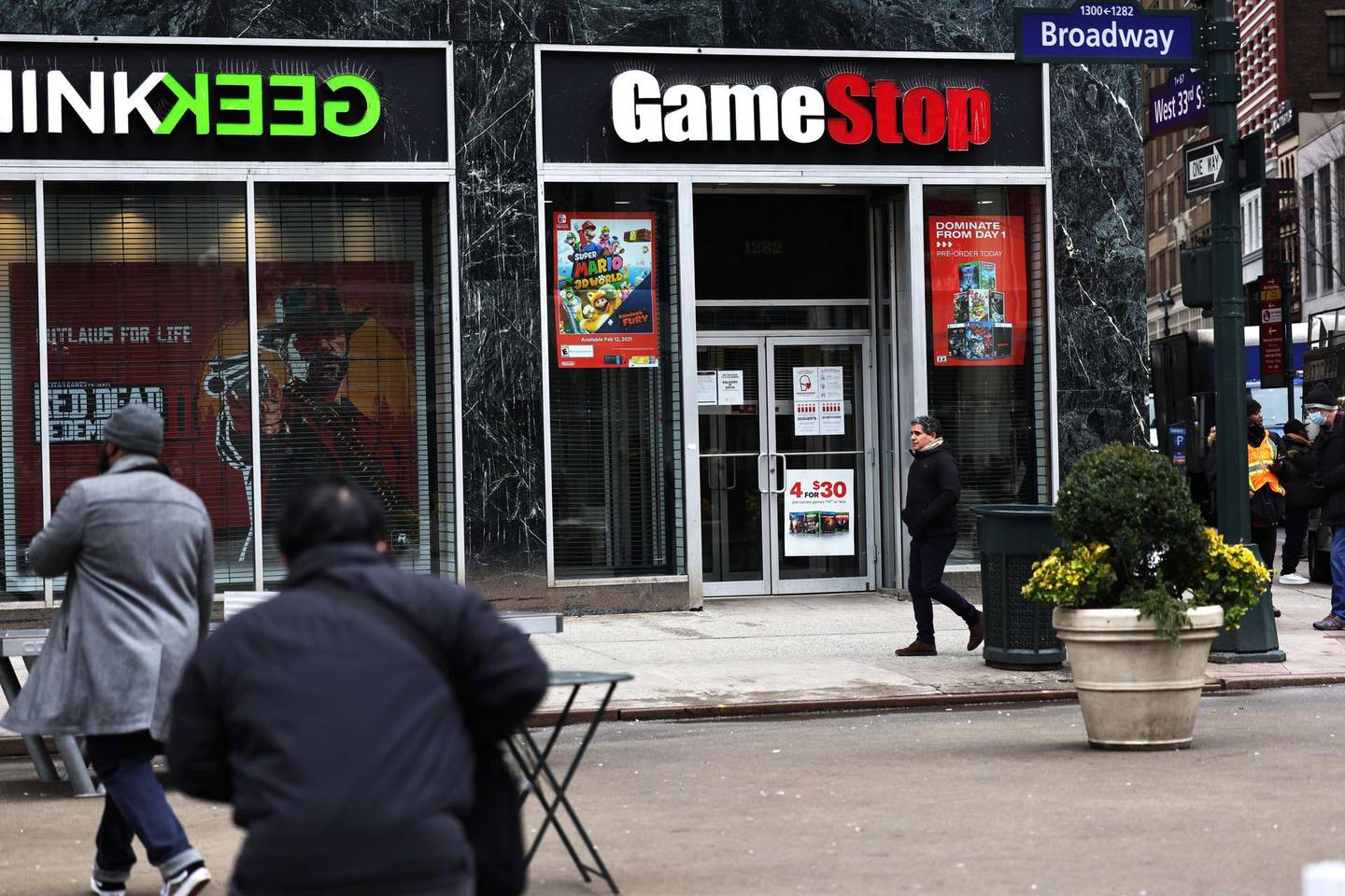 NEW YORK, NEW YORK - JANUARY 27: People walk past a GameStop store in Midtown Manhattan on January 27, 2021 in New York City. Stock shares of videogame retailer GameStop Corp has increased 700% in the past two weeks due to amateur investors.   Michael M. Santiago/Getty Images/AFP
== FOR NEWSPAPERS, INTERNET, TELCOS & TELEVISION USE ONLY ==
