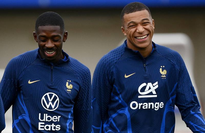 France forward Ousmane Dembele jokes with Kylian Mbappe. AFP