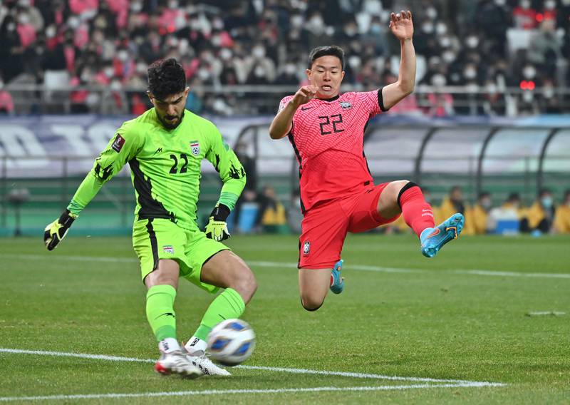 South Korea's Kwon Chang-hoon attempts to charge down a clearance by Iran goalkeeper Amir Abed Zadeh. AFP