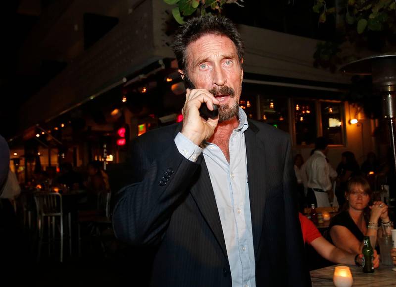 McAfee talks on his mobile phone as he walks on Ocean Drive in the South Beach area of Miami, Florida in 2012. AP