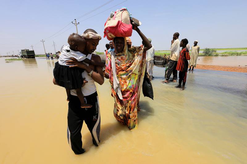 Crossing the floodwaters in Al Manaqil, in Sudan's Al Jazira state. Reuters