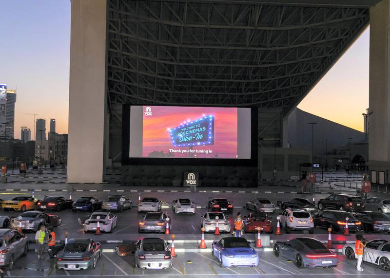 DUBAI, UNITED ARAB EMIRATES. 13 MAY 2020. The drive-in cinema is making a comeback at Mall Of The Emirates, as the property and VOX Cinemas take the movie-going experience outdoors.With social distancing measures keeping traditional theatres closed for the foreseeable future, a large screen has been assembled in the shopping centre's upper parking lot (level 3 near Ski Dubai) in front of which patrons will be able to take position, switch off their engines and settle in for some silver screen action all while observing sensible practices to combat the COVID-19 pandemic.  (Photo: Reem Mohammed/The National)Reporter:Section: