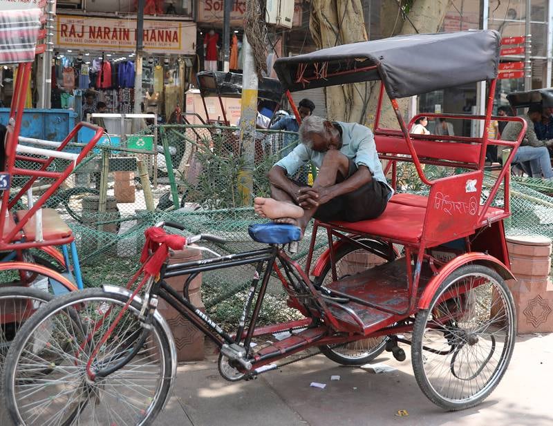 A rickshaw puller takes a rest in scorching heat in Delhi. EPA