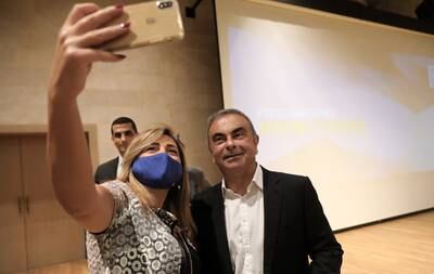Mr Ghosn poses for a selfie after a press conference to launch a joint initiative with the University of Kaslik in Jounieh, Lebanon in September 2020. AFP