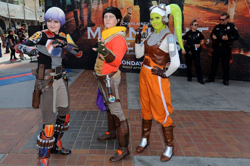 Costumed attendees pose for pictures as police officers look on at Comic Con International. Mike Blake / Reuters