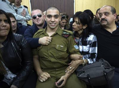 Israeli solider Elor Azaria waits with his parents for the verdict inside the military court in Tel Aviv. He was found guilty of manslaughter for shooting wounded Palestinian Fatah Al Sharif as he lay on the ground. Heidi Levine / AP Photo
