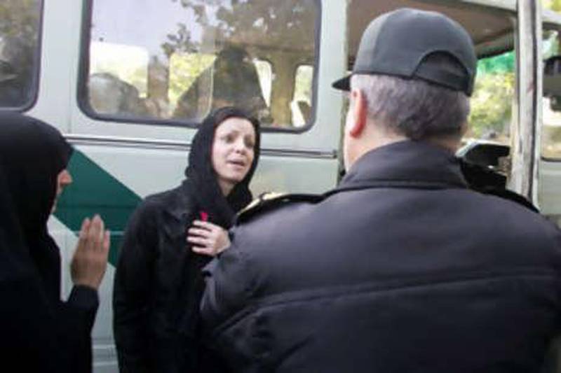 An Iranian woman objects to a policeman (R) and a policewoman (L) ordering her to get into the police bus due to her clothing and hair during a crackdown to enforce Islamic dress code in Tehran 23 April 2007. The police bus screeches to a halt at a Tehran square packed with traffic. The officers leap out and begin spot checks on passing pedestrians and cars. Police work apparently like any other place in the world. But here in the Iranian capital their targets are women deemed to have infringed the Islamic republic's strict dress rules. AFP PHOTO/ATTA KENARE