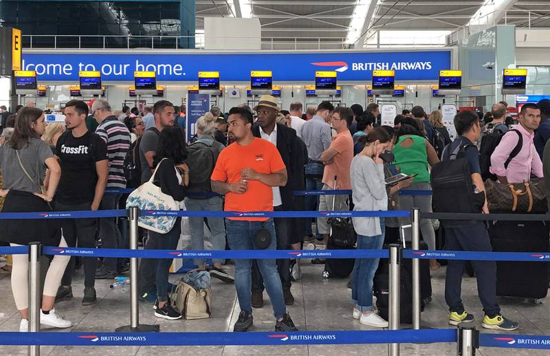Passengers queue for check-in at Heathrow Airport's Terminal 5. PA