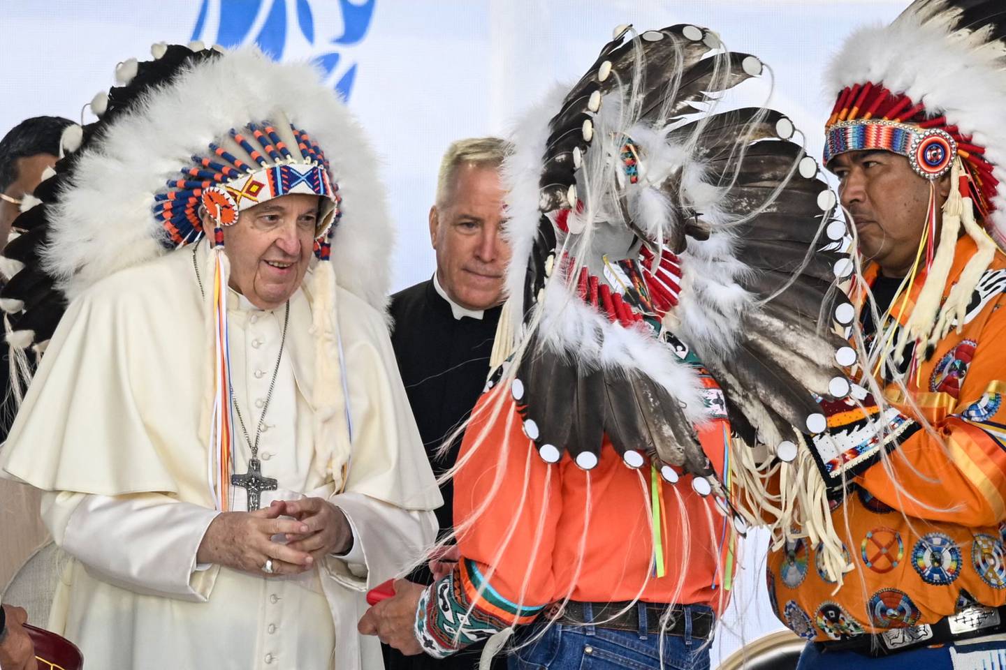 Pope Francis wears a headdress presented to him by indigenous leaders during a meeting at Muskwa Park in Maskwacis, Alberta. AFP
