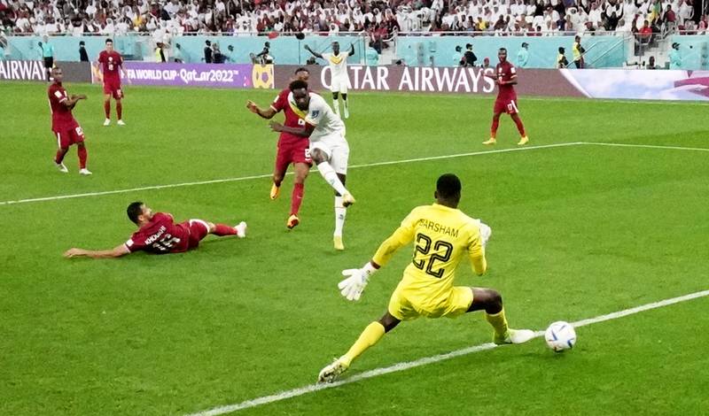 Senegal's Boulaye Dia past Qatar goalkeeeper Meshaal Barsham. Reuters