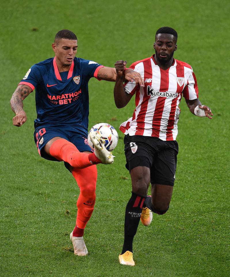 BILBAO, SPAIN - OCTOBER 31: Diego Carlos of Sevilla  battles for possession with  Inaki Williams of Athletic Bilbao  during the La Liga Santander match between Athletic Club and Sevilla FC at Estadio de San Mames on October 31, 2020 in Bilbao, Spain. Sporting stadiums around Spain remain under strict restrictions due to the Coronavirus Pandemic as Government social distancing laws prohibit fans inside venues resulting in games being played behind closed doors. (Photo by Juan Manuel Serrano Arce/Getty Images)
