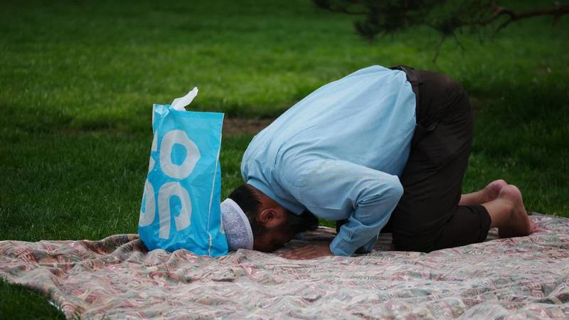 Shortlisted: 'Park Picnic and Prayer' by Touseef Ahmad. 'I was in the park and spotted this man praying. His devotion was admirable and his clothes matched up with the bag in front of him.'