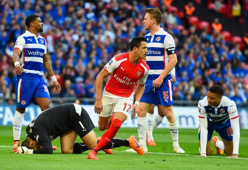 Alexis Sanchez begins to celebrate and Reading players react after he scores one of his two goals on Saturday to lead Arsenal into the FA Cup Final with a 2-1 win. Mike Hewitt / Getty Images / April 18, 2015 