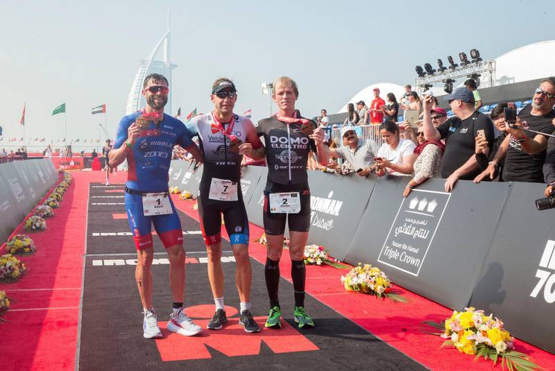 Dubai, United Arab Emirates - (L-R) Adam Bowden (3rd) Bart Aernouts (1st) and Pieter Heemeryck (2nd) winner of Ironman men's pro at the Ironman race at Jumeirah open beach, Dubai. Leslie Pableo for The National