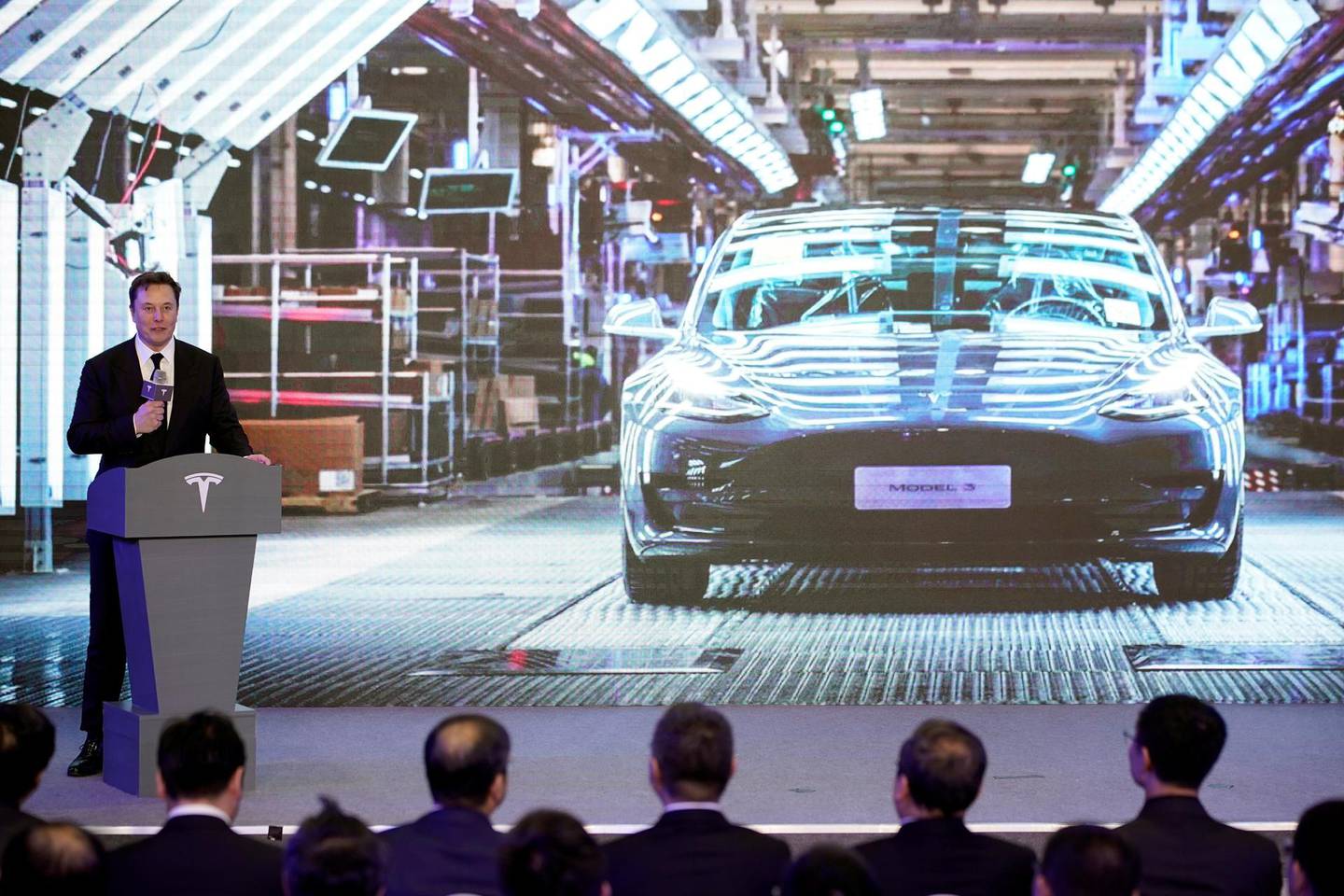 Tesla Inc CEO Elon Musk speaks next to a screen showing an image of Tesla Model 3 car during an opening ceremony for Tesla China-made Model Y program in Shanghai, China January 7, 2020. REUTERS/Aly Song
