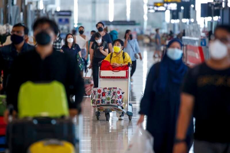 Travellers at the international airport in Samut Prakan, Thailand. Authorities have suspended quarantine-free entry to the country for all passengers, to contain the spread of the Omicron variant. EPA