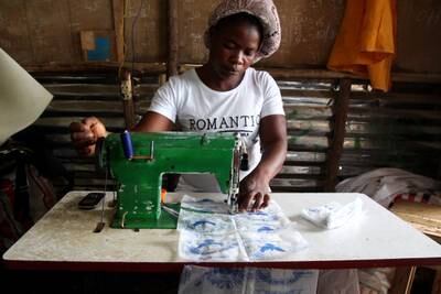 Tenneh Sumowood, a seamstress, sews together used plastic sachets as part of a recycling process at the Environmental Rescue Initiative in Montserrado County, Liberia.  EPA 