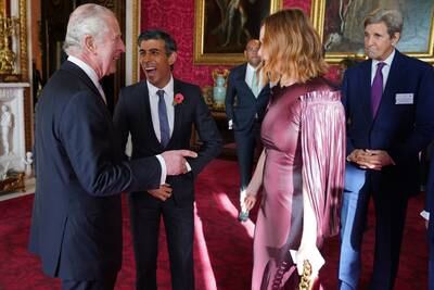 King Charles speaks with Prime Minister Rishi Sunak, Stella McCartney and US Special Presidential Envoy for Climate John Kerry during a reception at Buckingham Palace ahead of the Cop27 Summit in November 2022
