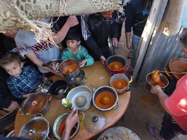 Libyans cook a traditional meal as they break their fast in Tajoura, east of Libya's capital Tripoli, during Ramadan, April 11, 2022.  AFP