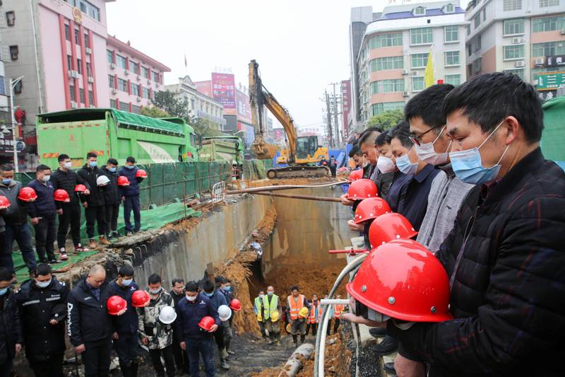 Workers observe a moment of silence at a construction site in Shaoyang, Hunan province. China Daily via Reuters