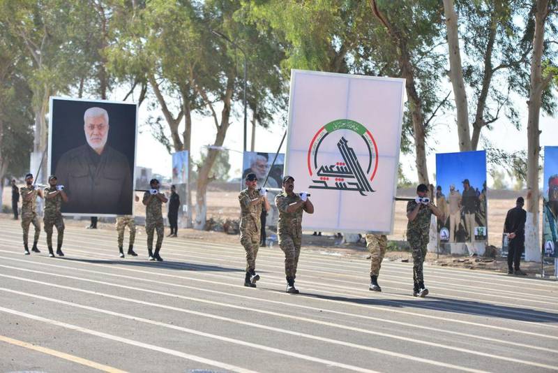 Members of Iraq's Popular Mobilisation Forces take part in a parade to mark the seventh anniversary of the organisation's founding at Camp Ashraf in Diyala province. AFP