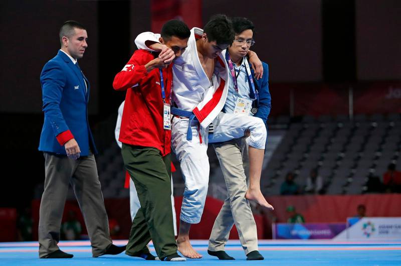Khalid Iskander Al Balushi of the UAE is carried off the mat during the men’s 56kg gold medal match against fellow Emirati Hamad Nawad. Issei Kato / Reuters