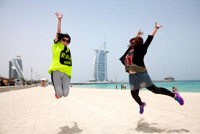 Dubai, United Arab Emirates, May 23, 2013 -   Tourists from Hong kong - China pose for a picture in front of the Burj al Arab hotel. ( Jaime Puebla / The National Newspaper ) 