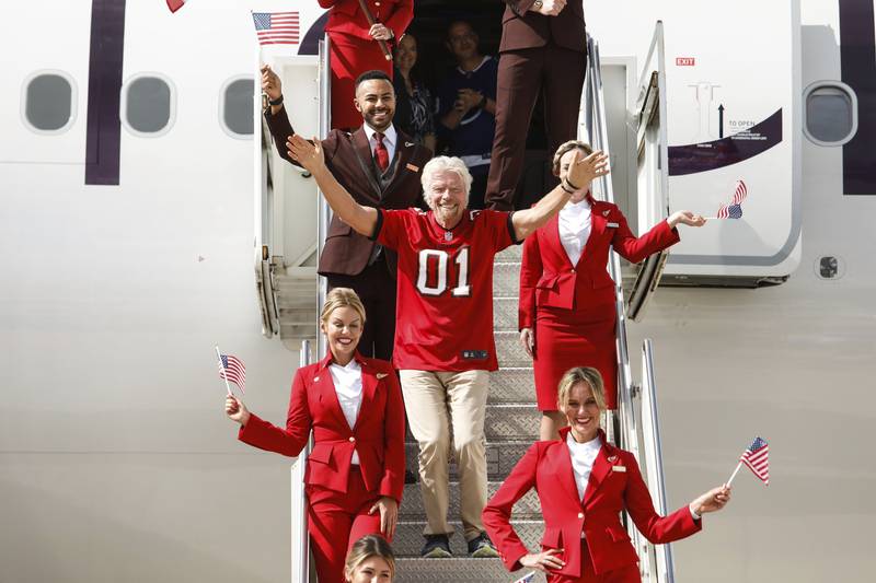 Virgin Atlantic founder and president Richard Branson greets the crowd after arriving at Tampa International Airport in Florida. AP