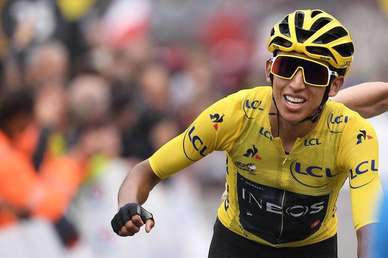 Colombia's Egan Bernal, wearing the overall leader's yellow jersey celebrates as he crosses the finish line of the twentieth stage of the 106th edition of the Tour de France cycling race between Albertville and Val Thorens, in Val Thorens, on July 27, 2019.  / AFP / Marco Bertorello
