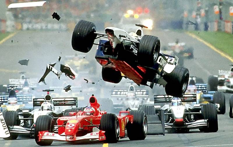 Williams driver Ralf Schumacher (C) is launched in the air over Ferrari driver Rubens Barrichello of Brazil (front red) in a dramatic Australian F1 Grand Prix, at the Albert Park Circuit in Melbourne, 03 March 2002.  Ferrari driver Michael Schumacher of Germany won the incident packed race in which only eight cars finished with Juan Pablo Montoya of Colombia placed second in his Williams and Finland's Kimi Raikkonen third in a McLaren. AFP