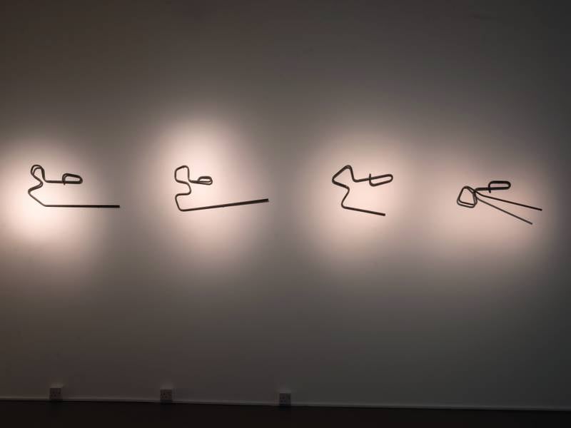 Bending Directions (Abubaker, Abdulrahman) features bent metal rods made by construction workers. Al Amri says that every time they attempted to model the rods into a ‘sah’, the repetition only resulted in the collapse of the 'correctness'.