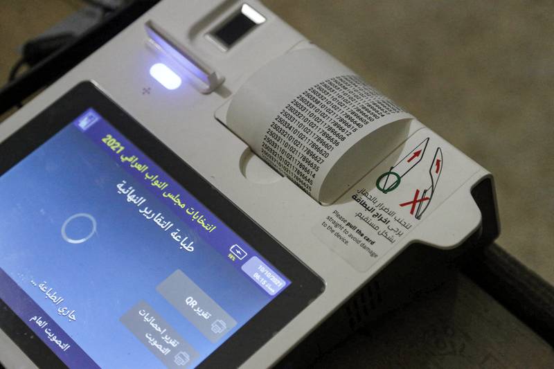 Iraqi officials print out the electronic count of votes at a polling station in Karbala. AFP