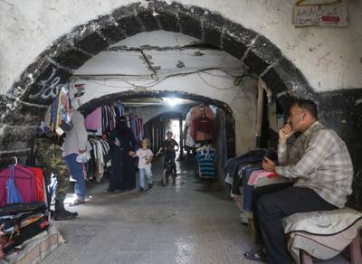 Syrians shop for clothes at a flea market in the capital Damascus on May 17, 2020, amid severe economic crisis that has been compounded by a coronavirus lockdown. - Prices have doubled over the past year, while the Syrian pound has reached record lows against the dollar, further driving up inflation. 
With most of the population living in poverty, Syrians have increasingly turned to flea markets to purchase clothes at a reasonable price. 