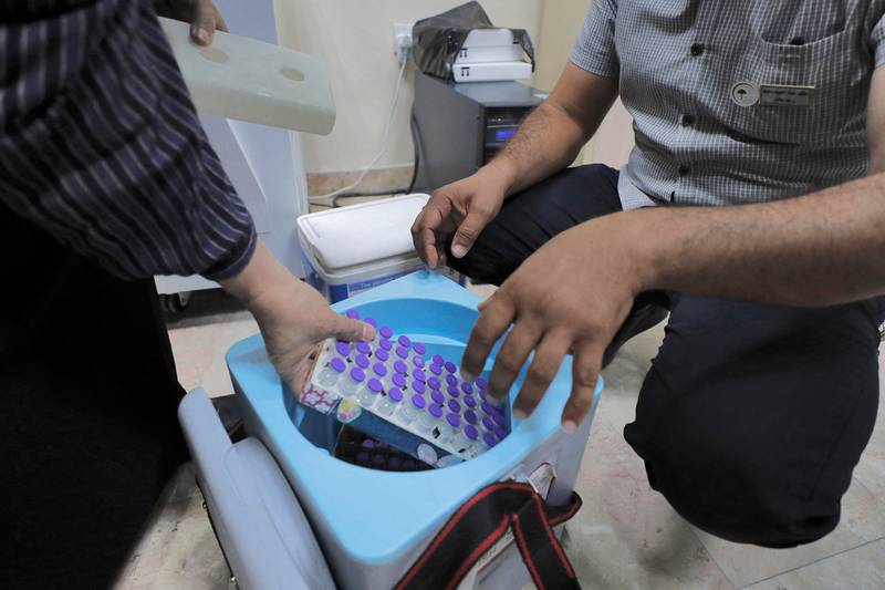 Refrigerated Pfizer-BioNTech coronavirus vaccines being unpacked at an inoculation centre in Baghdad.