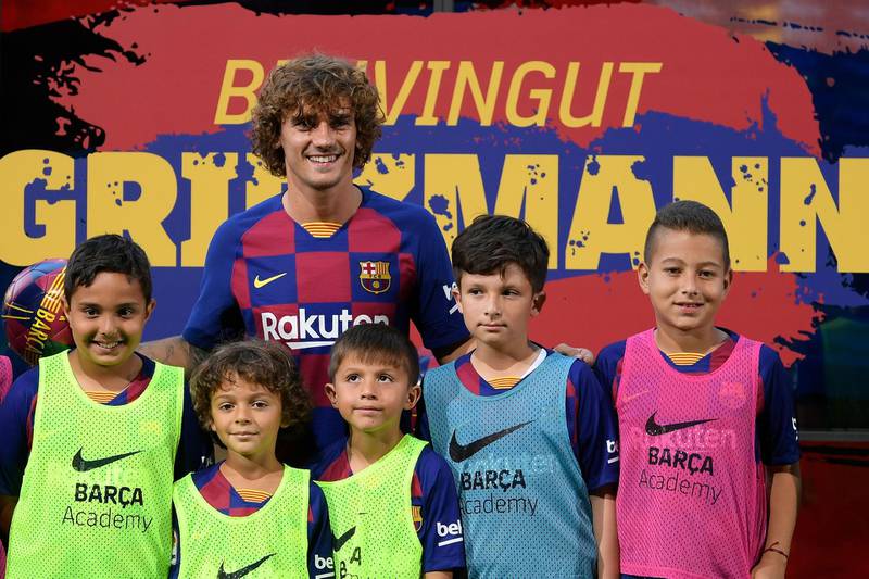 Barcelona's new French forward Antoine Griezmann poses with young Barcelona fans during his official presentation. AFP