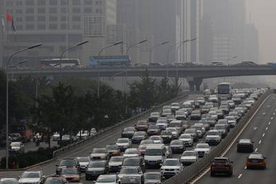 Automobiles and coaches come to a standstill during a traffic jam as haze covers the highway in Beijing, China, on Friday, July 29, 2016. As China's travel market takes off, all eyes should be on the country's roughly 400 million millennials, who will drive spending on airfare, hotels, theme parks, casinos and cruises. Photographer: Luke MacGregor/Bloomberg