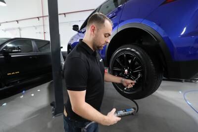 Ryan checks the tyre pressure to help protect against potential dramas on the road.