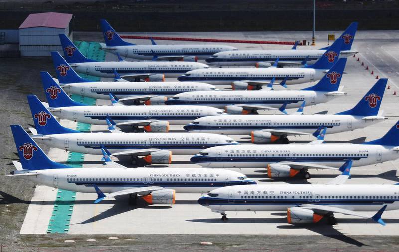 (FILES) In this file photo taken on June 05, 2019 shows grounded China Southern Airlines Boeing 737 MAX aircraft parked in a line at Urumqi airport, in China's western Xinjiiang region.  Boeing could on Monday announce whether to further cut or suspend production of its grounded 737 MAX plane, The Wall Street Journal reported December 15, 2019.
 / AFP / GREG BAKER
