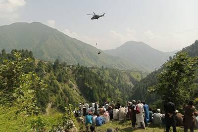 A commando drops from a helicopter during a bid to rescue people from a stranded cable car in north-western Pakistan. AFP
